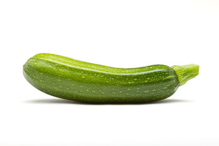 Single Courgette or zucchini from low perspective isolated on white.の写真素材