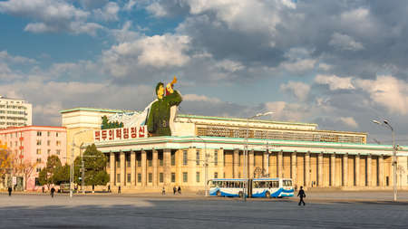 Pyongyang / DPR Korea - November 12, 2015: Kim Il-sung Square and government buildings decorated with flags and revolutionary slogans in Pyongyang, North Koreaのeditorial素材
