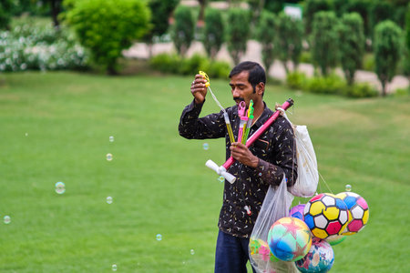 Delhi / India - September 22, 2019: Man selling toys in Lodhi Gardens in New Delhi, India