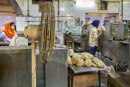 New Delhi / India - September 21, 2019: Volunteers preparing free food for visitors in the Gurdwara...
