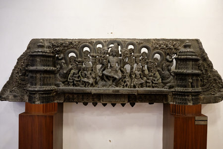 New Delhi / India - September 26, 2019: Ornamental stone carved lintel relief showing trinity of...