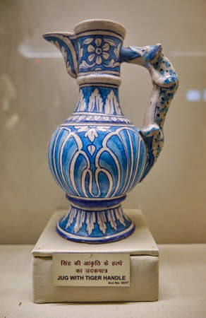 Jaipur, Rajasthan / India - September 29, 2019: Glazed Peshawar pottery jug with tiger handle in Albert Hall Museum in Jaipur, Rajasthan, Indiaのeditorial素材