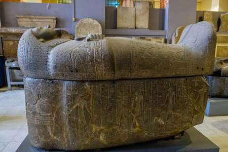 Cairo / Egypt - May 25, 2019: Ancient Egyptian sarcophagi and mummy caskets displayed in the Museum...
