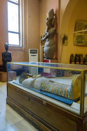 Cairo / Egypt - May 25, 2019: Ancient Egyptian sarcophagi and mummy caskets displayed in the Museum...