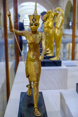 Cairo / Egypt - May 25, 2019: Golden statuettes depicting pharaoh in Museum of Egyptian Antiquities,...