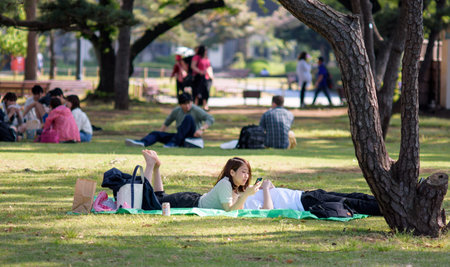Tokyo / Japan - April 22, 2018: People picnicking and enjoying in Kokyogaien Park in Tokyo, Japan