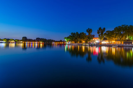 Beijing / China - July 2, 2016: Peaceful reflection of the evening blue hour in Shichahai lake in Beijing, Chinaのeditorial素材