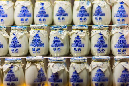 Beijing / China - July 17, 2016: Cups of Lao Beijing Suannai, popular old-style Beijing yogurt made...