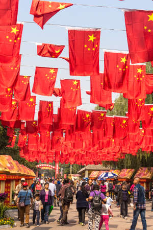 Beijing / China - October 5, 2015: Flags of the Peoples Republic of China, hanging in a park during National Day celebration in Beijing, Chinaのeditorial素材