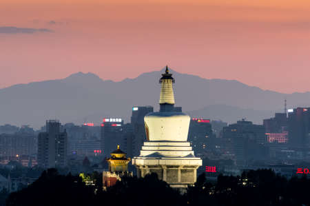 Beijing / China - June 19, 2015: Sunset view of White Pagoda in Beihai park and Beijing skyline, Chinaのeditorial素材