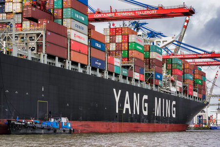 Hamburg / Germany - February 21, 2017: Container terminal and huge container ship YM WITNESS loaded...