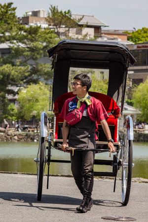 Nara / Japan - May 12, 2018: Young Japanese rickshaw puller in Nara, Japan