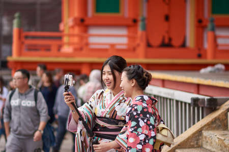 Kyoto / Japan - November 3, 2017: Pretty Japanese girls dressed in traditional kimonos, taking selfies at Kiyomizu-dera temple in Kyoto, Japanのeditorial素材