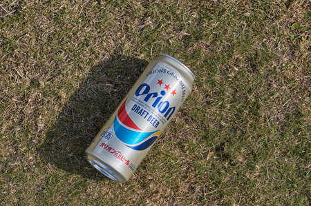 Okinawa / Japan - February 27, 2018: Can of Orion Beer, popular Okinawa beer, laying on a lawnのeditorial素材