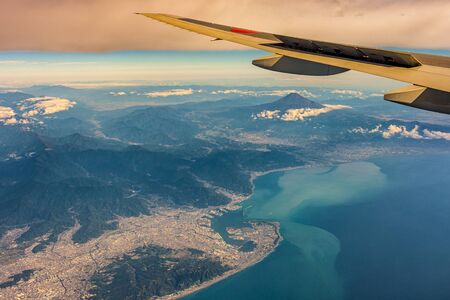 Aerial view of Shizuoka and Suruga Bay, with Mount Fuji in the distance in Japanの写真素材