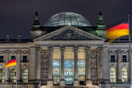 Berlin / Germany - February 28, 2017: Reichstag building (Deutscher Bundestag) at night, the dedication Dem deutschen Volke, meaning To the German people, can be seen on the frieze.のeditorial素材