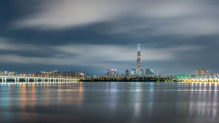 Night view of Lotte World Tower skyscraper and Han River in Seoul South Korea on 5 August 2022の写真素材
