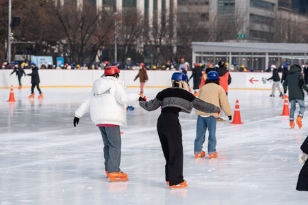 People ice skating on the temporary ice skating ring in front of the City Hall in Seoul South Korea...