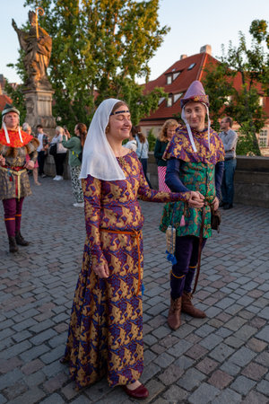 Sunrise parade medieval historic reenactment to commemorate 667th anniversary of laying the foundation stone of iconic Charles Bridge in Prague, Czech Republic, on 9 July 2024のeditorial素材