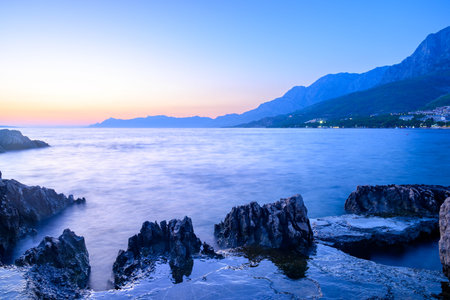 Colorful sunset on Makarska Riviera, popular touristic coastline of the Adriatic Sea in...