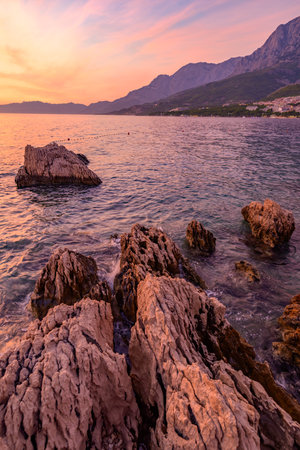 Colorful sunset on Makarska Riviera, popular touristic coastline of the Adriatic Sea in Split-Dalmatia County of the Republic of Croatiaの写真素材