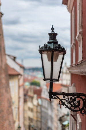 Vintage street lamp on a narrow European street with blurred buildingsの写真素材