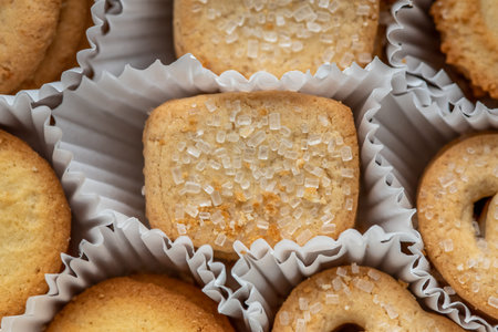 Close-up of sugar-topped Danish butter cookies in paper cups.