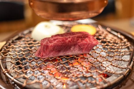 Close-up of raw beef steak on a Korean grill barbecue with vegetablesの写真素材