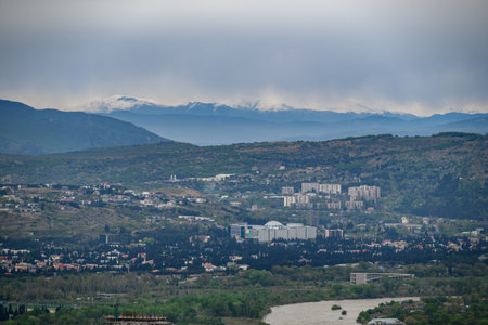 Cityscape view of Tbilisi, the capital of Georgia with snow-capped Caucasus mountains in the...