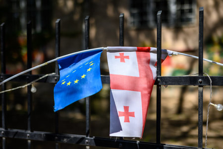 European Union and Georgian flags hanging on a metal fence in Tbilisi, Georgiaの写真素材