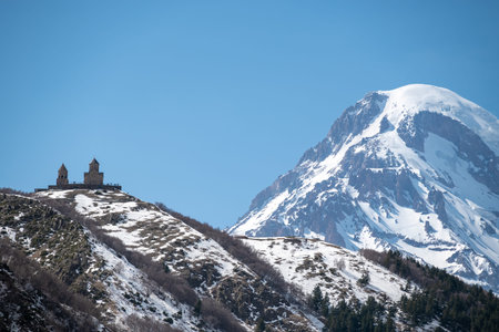 Gergeti Trinity Church and Mount Kazbek near the village of Stepantsminda, popular tourist...