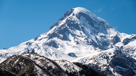 Gergeti Trinity Church and Mount Kazbek near the village of Stepantsminda, popular tourist...