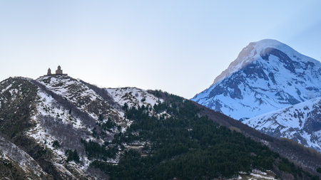 Gergeti Trinity Church and Mount Kazbek near the village of Stepantsminda, popular tourist destination in the Caucasus mountains in Georgiaの写真素材