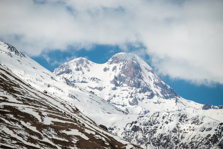 Mount Kazbek, dormant stratovolcano and one of the highest peaks of Caucasus mountain range, near the village of Stepantsminda, popular tourist destination in Georgiaの写真素材