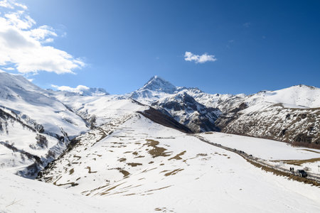 Mount Kazbek, dormant stratovolcano and one of the highest peaks of Caucasus mountain range, near the village of Stepantsminda, popular tourist destination in Georgia on 19 April 2025の写真素材