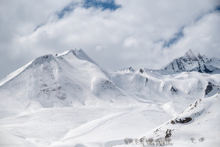 Snowcapped peaks of Caucasus mountains along the Georgian Military Road, major route from Georgia to Russia connecting Tbilisi and Vladikavkazの写真素材