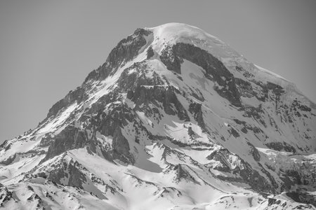 Mount Kazbek, dormant stratovolcano and one of the highest peaks of Caucasus mountain range, near the village of Stepantsminda, popular tourist destination in Georgiaの写真素材