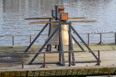 Bell #9801 on a pontoon in the Vltava river, commemorating cultural loss of 9801 bells taken by...