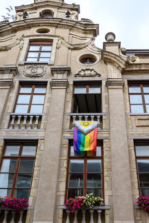 Progressive rainbow pride flag hanging from the balcony of an old building in historic city center of Brussels, Belgium on 15 July 2025の写真素材