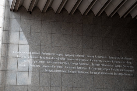 European Parliament text in official EU languages at Espace Leopold or Leopoldruimte, complex of European Parliament buildings in the European Quarter of Brussels, Belgium on 16 July 2025の写真素材