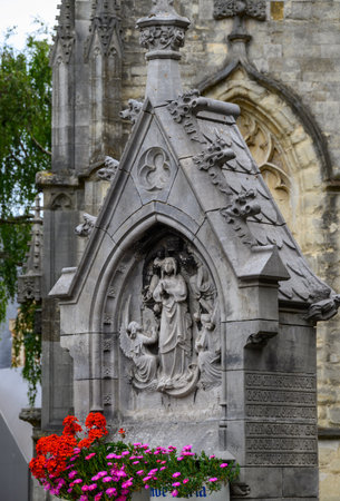 Gothic stone sculpture with religious figures on a church facade.の写真素材