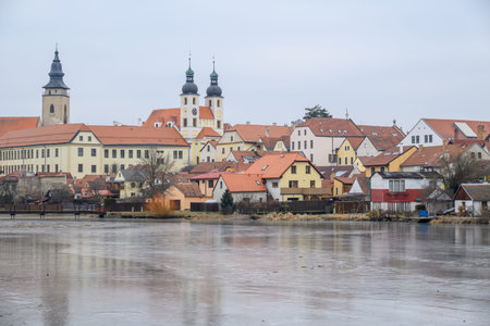 View of Historic old town of Telc, Unesco World Heritage Site, across the frozen Ulicky rybnik pond in winter, in Telc, Czech Republic on 8 February 2025の写真素材