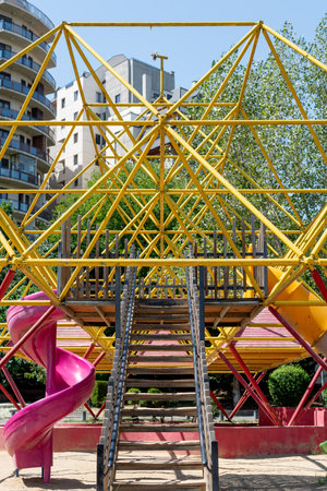 Colorful playground structure with slides and climbing frames.の写真素材