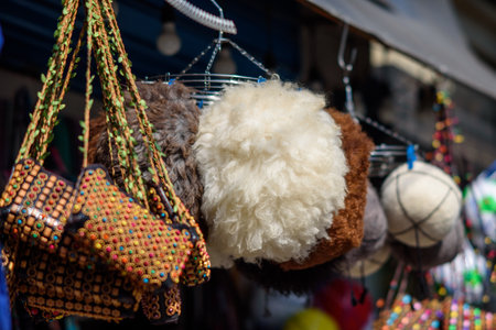 Colorful market stall with handmade bags and wool hats.の写真素材