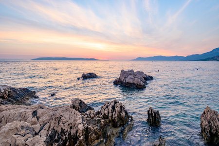 Colorful sunset on Makarska Riviera, popular touristic coastline of the Adriatic Sea in...