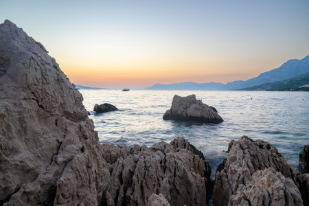 Colorful sunset on Makarska Riviera, popular touristic coastline of the Adriatic Sea in Split-Dalmatia County of the Republic of Croatiaの写真素材