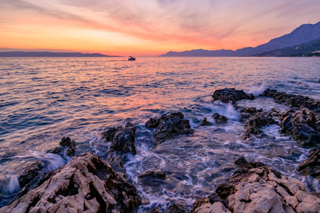 Colorful sunset on Makarska Riviera, popular touristic coastline of the Adriatic Sea in Split-Dalmatia County of the Republic of Croatiaの写真素材