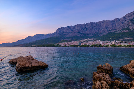 Sunset over Makarska town, popular tourist seaside summer resort on the Adriatic sea coastline of Croatia on 24 August 2024の写真素材