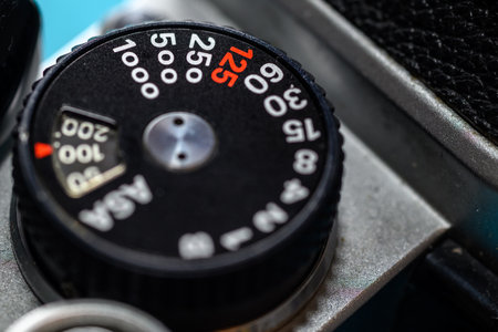 Close-up of a vintage camera shutter speed dial with numbers and ASA valuesの写真素材