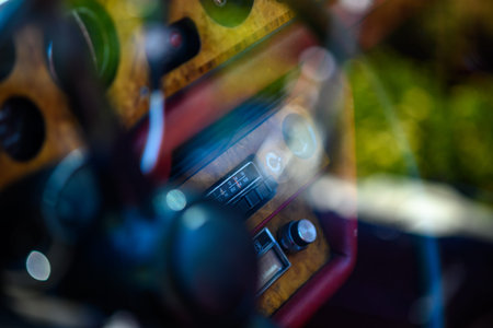 Close-up of a vintage car dashboard with wooden paneling and classic controls